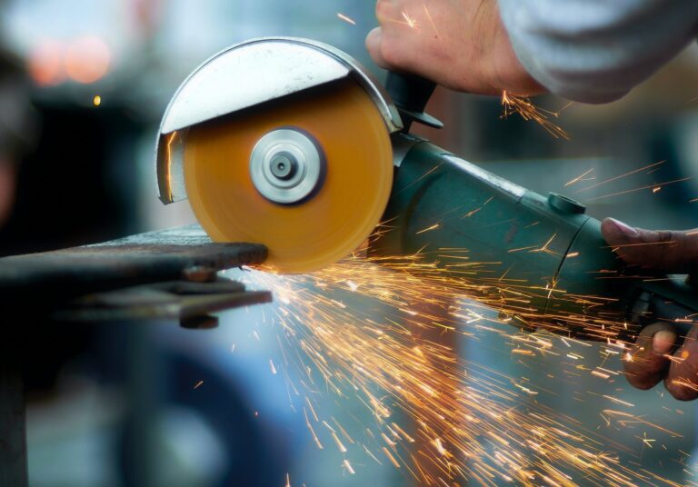 crop blacksmith cutting metal with grinder