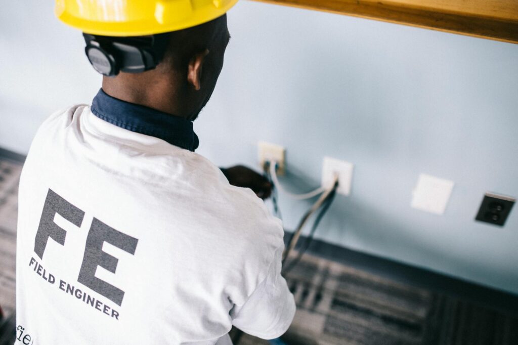 an electrician repairing the ac power plugs and sockets