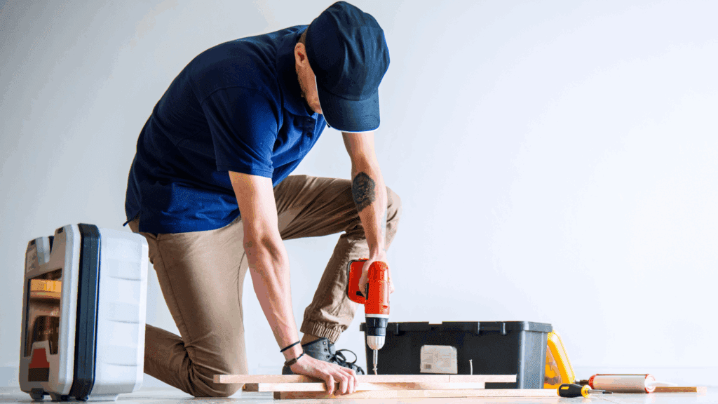 A man installing exhaust fan with light